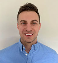 A headshot of Dylan Legrady against a white wall.