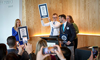 A researcher holds up an award at a press conference at 博彩网站.