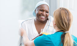 A nurse takes care of a cancer patient in a hospital.
