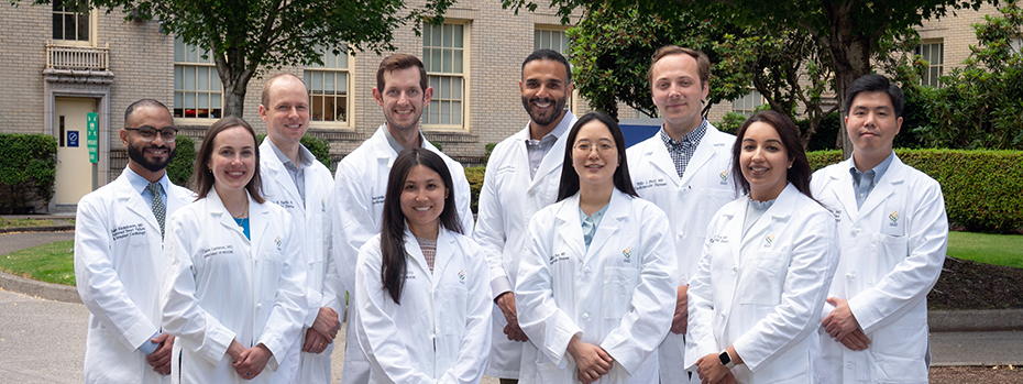 2024-25 Cardiovascular Disease Fellows posing outside in their white coats.