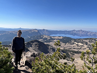 Shannon Huggins standing on a trail with a lake in the background.