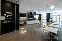 Food options at Blink Café at 博彩网站 include grab-and-go items, hot dishes, a coffee bar, and tables.