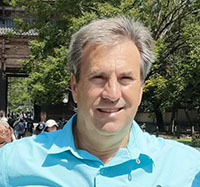 Headshot of Ben Cox wearing a blue shirt
