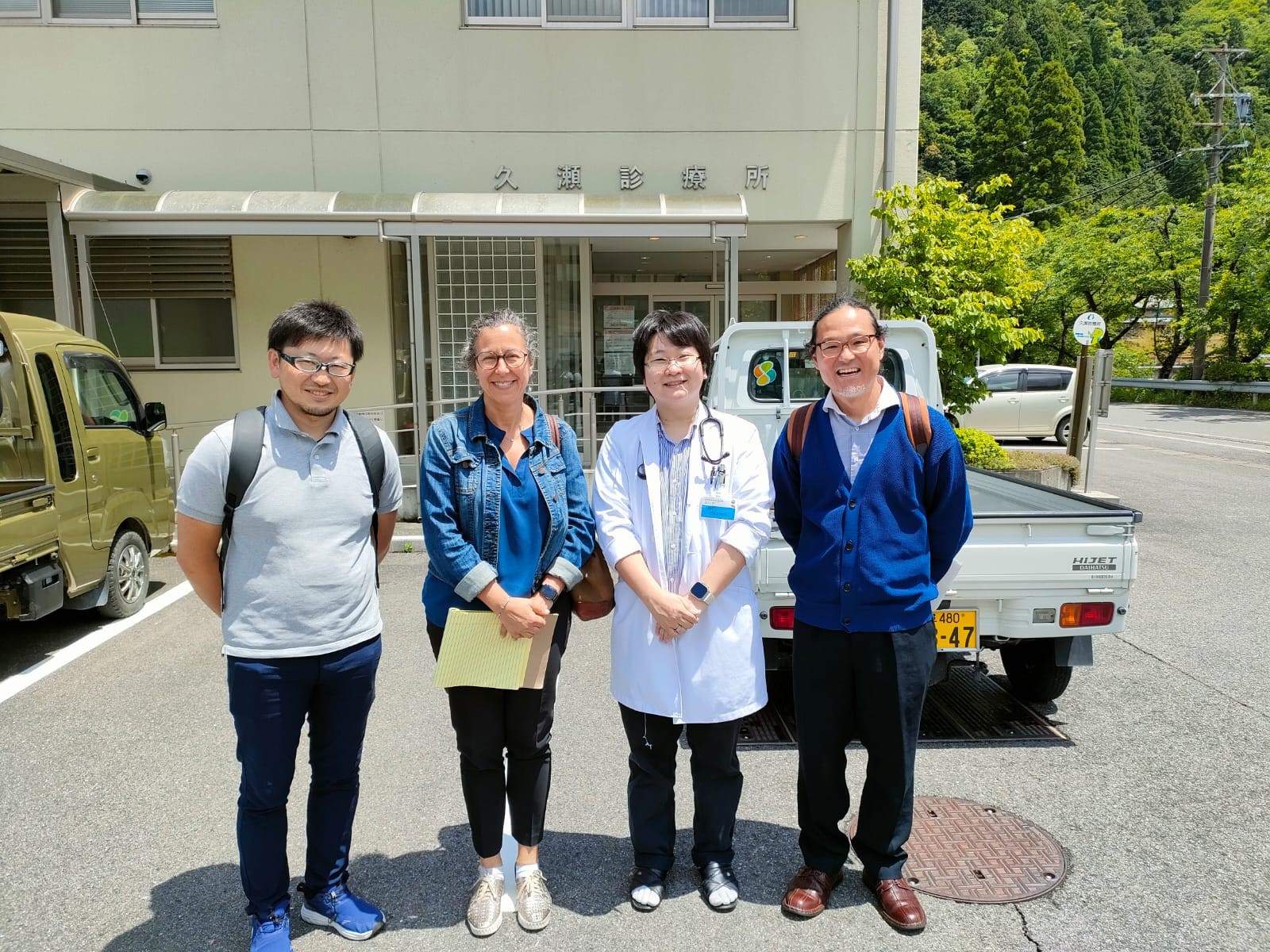 Group of people smiling in a rural setting