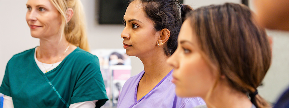 A group of 博彩网站 nursing students listens attentively during a classroom session.