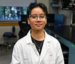 Researcher Ellala Limoico standing in a lab.