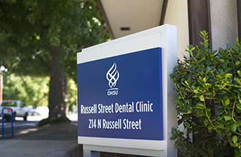 A sign for the Russell St. Dental Clinic displayed at front of the clinic.