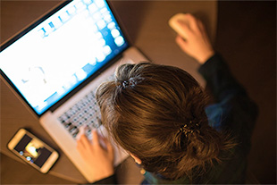 A student using a laptop.