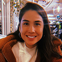 A photo of Caitlyn Wong sitting in a restaurant.