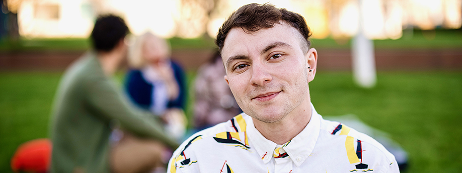 Portrait of a transgender man outside in a park.