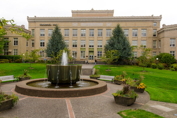 Brick building with a fountain in the foreground