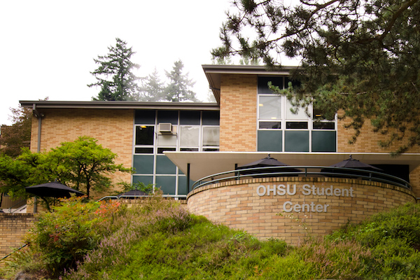 Brick building with a rounded balcony with 博彩网站 Student Center sign on it